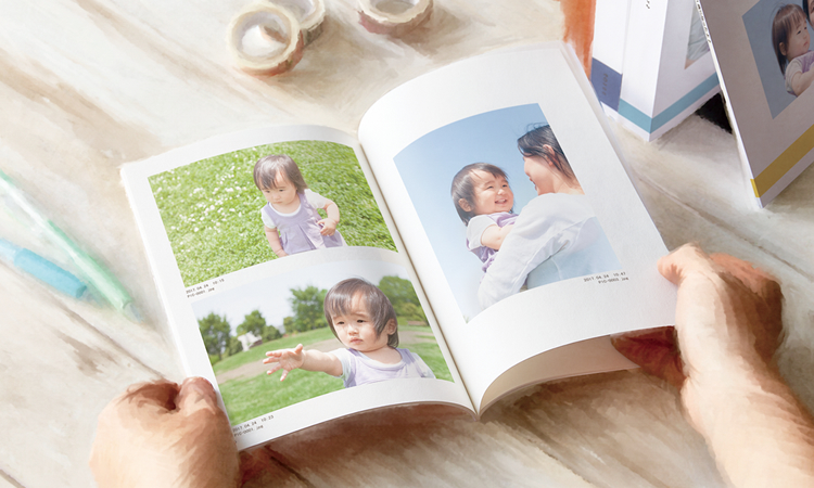 子どもの写真を収めたライトブックを開いた様子